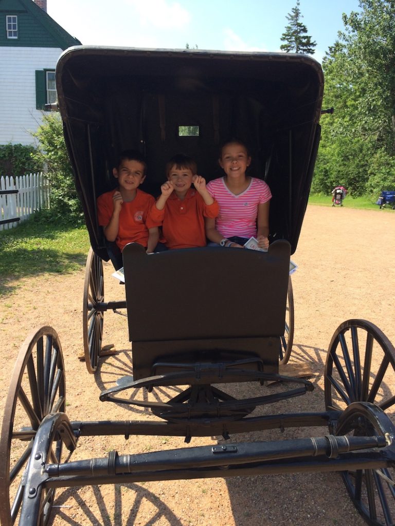 Sit in the carriage. Anne of Green Gables House with kids.